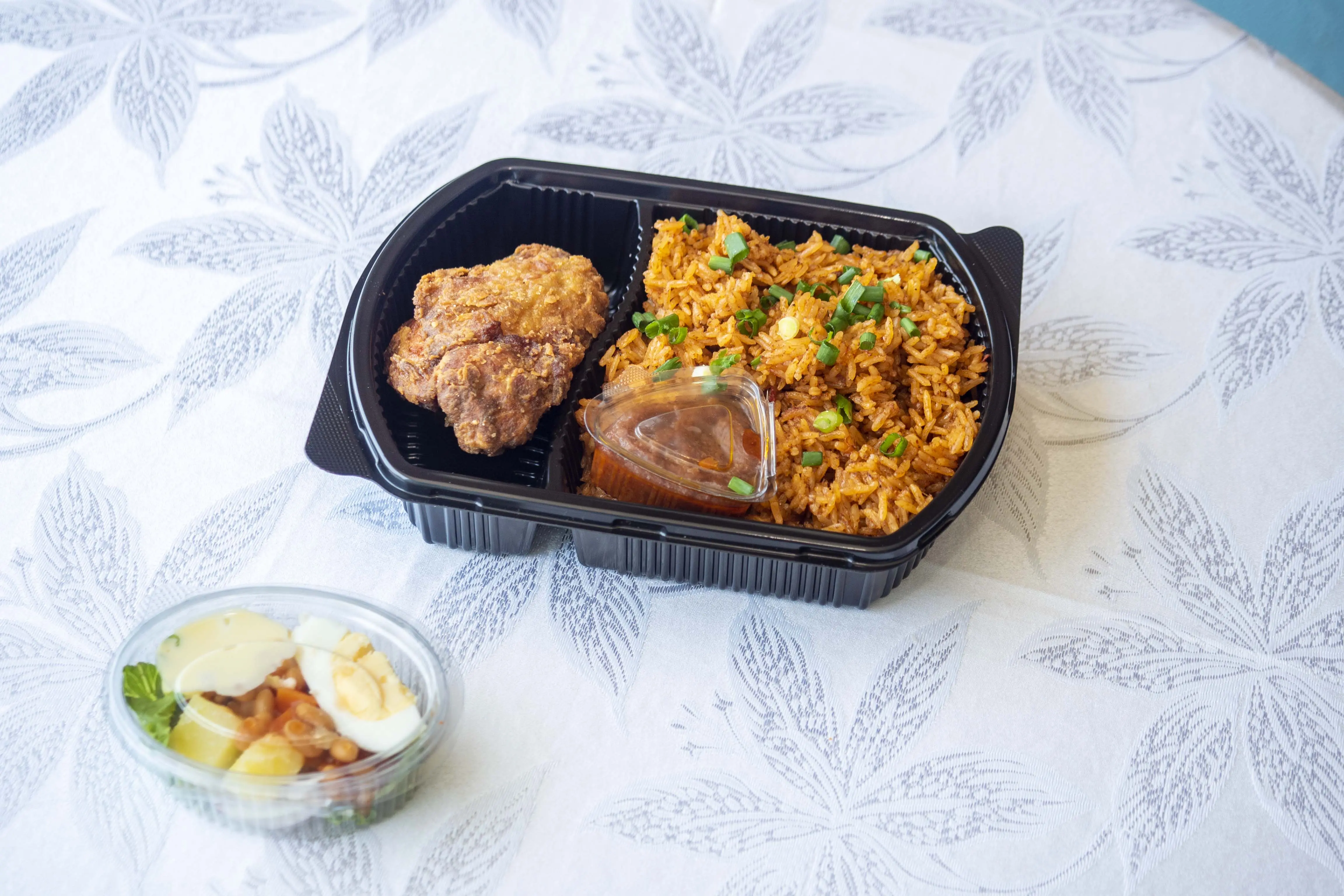 Jollof rice and fried chicken takeaway meal — Diamonds & Pearls Catering Accra